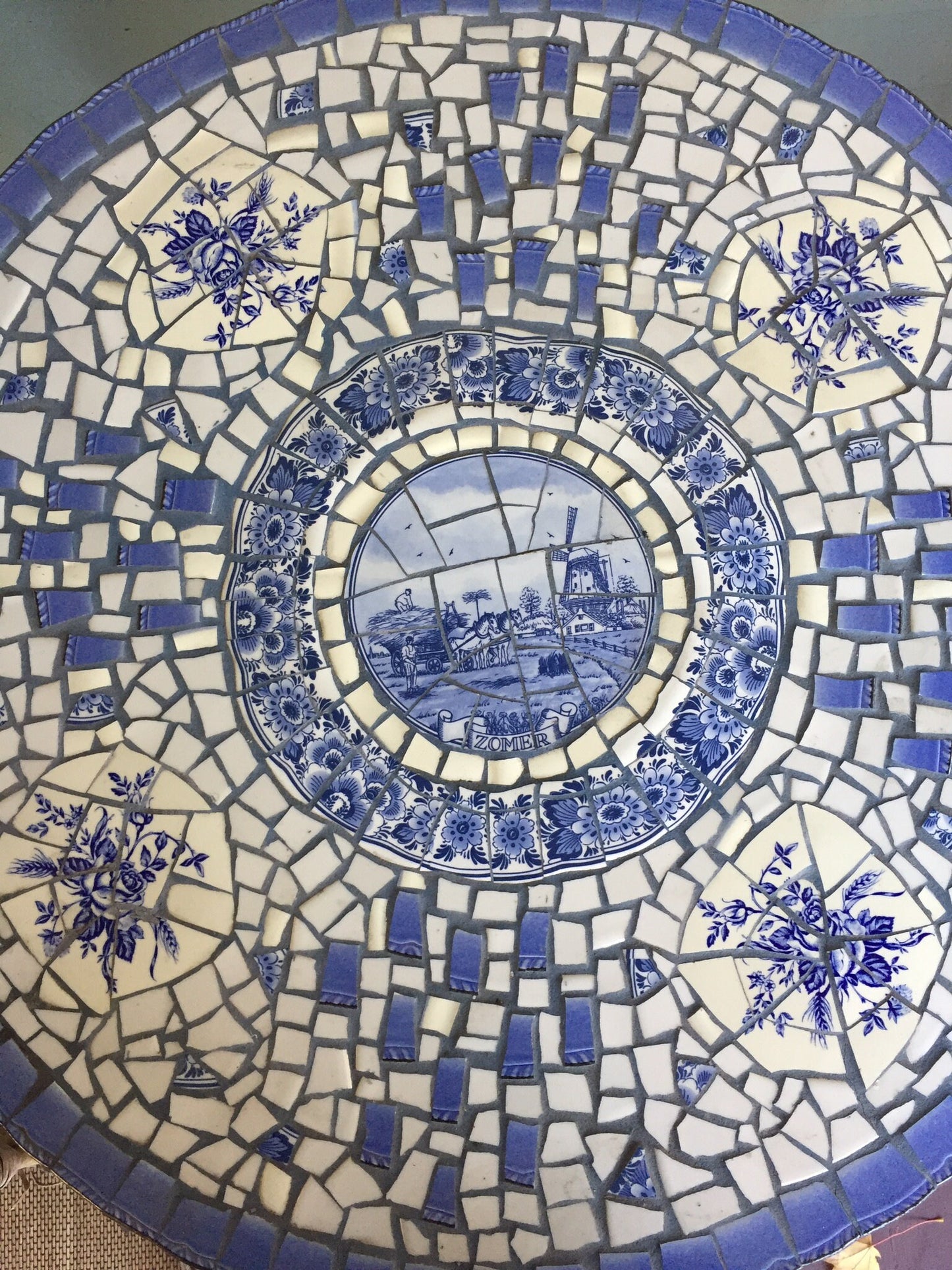 Mosaic cafe table on a wrought iron base. Blue Willow china. Broken Ceramic tiles. Gift idea for garden lover.