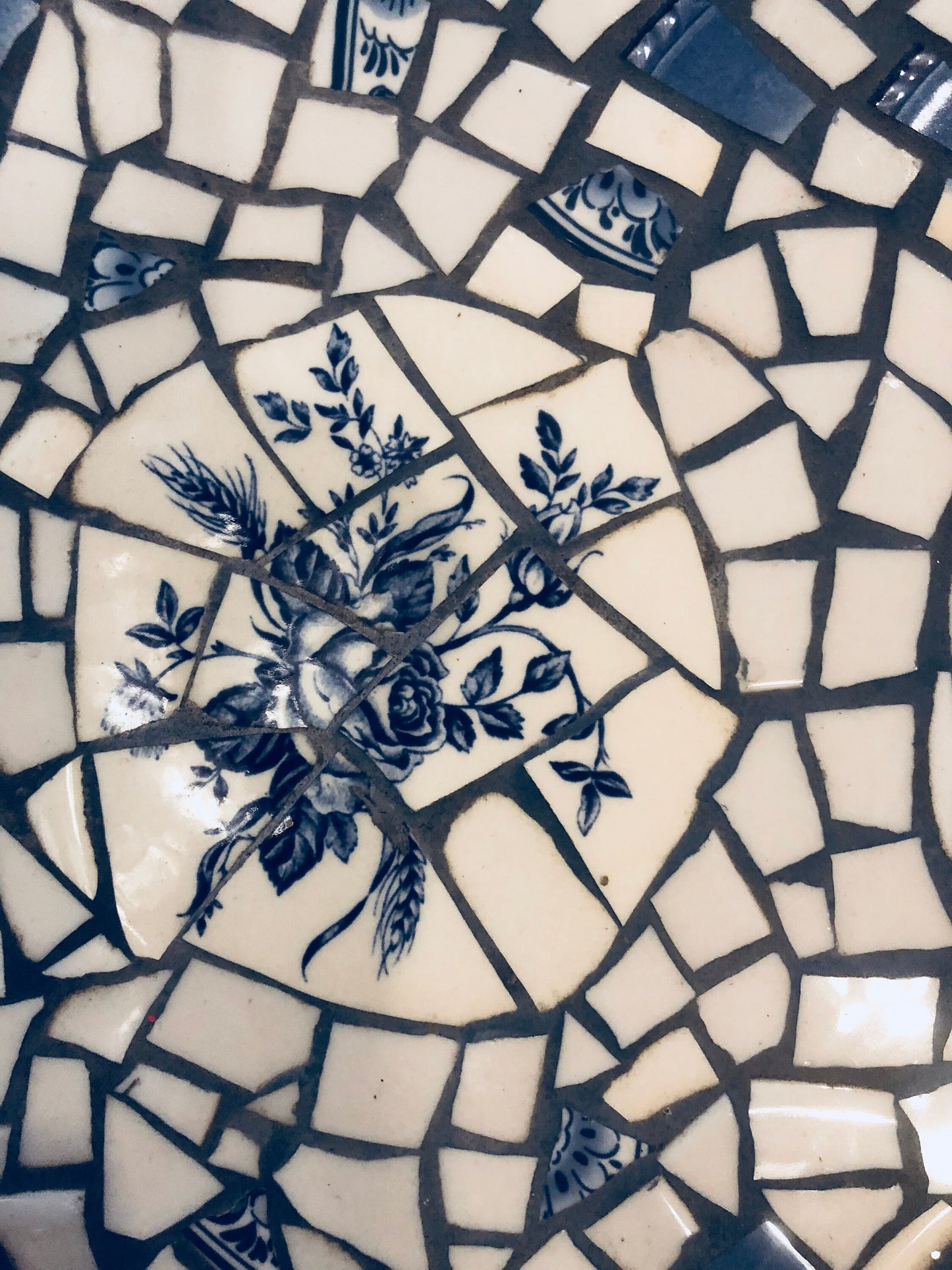 Mosaic cafe table on a wrought iron base. Blue Willow china. Broken Ceramic tiles. Gift idea for garden lover.
